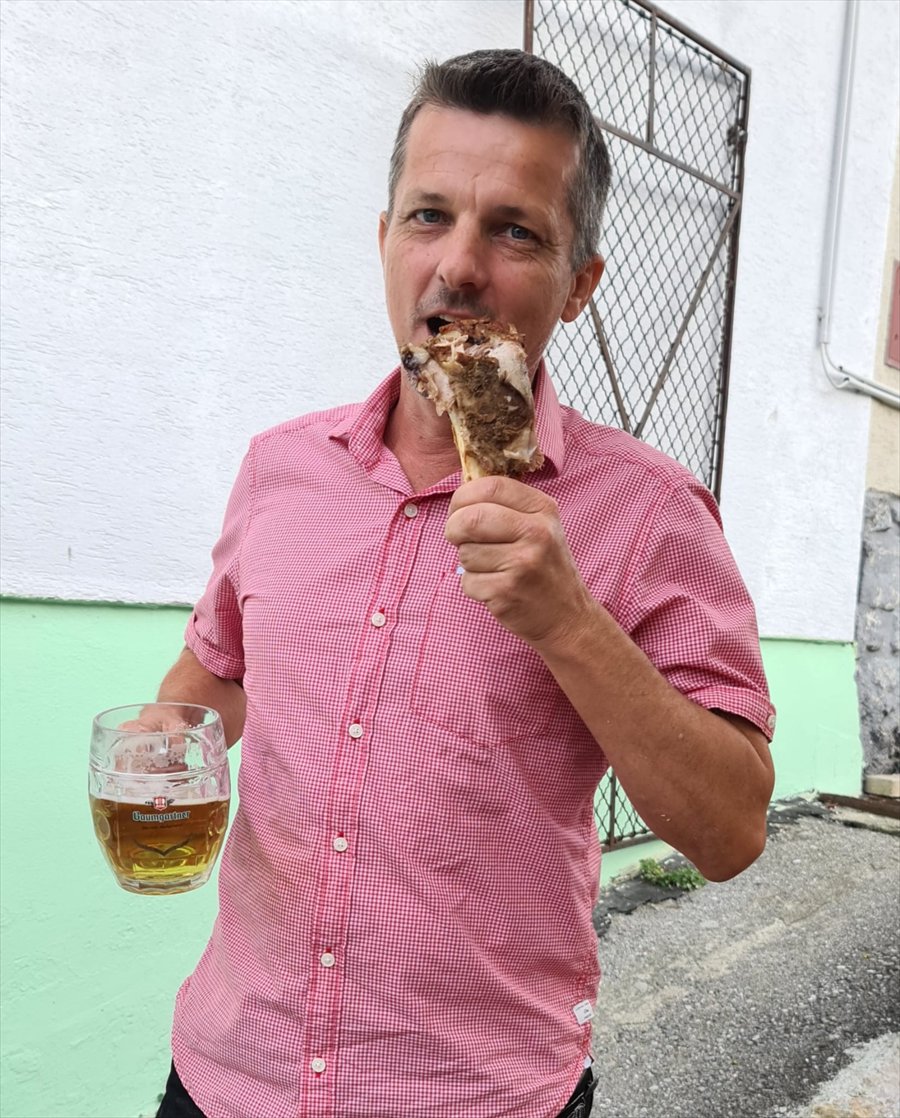 Bernd Rasner locker beim Essen mit einem Bier in der Hand
